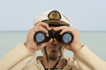 Captain looks through a binoculars