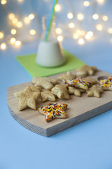 Sweet Christmas cookies with milk on wooden desks