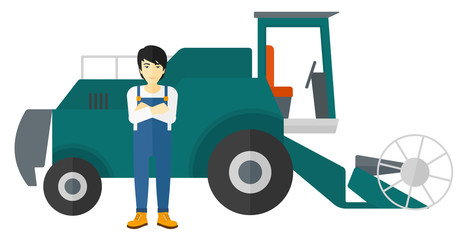 Man standing with combine on background.