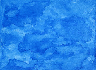 Painted blue abstract background on textured paper