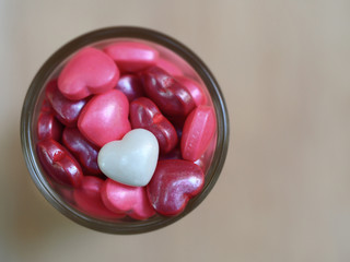 white heart shape sugar candy and pink heart shape background, valentine day love heart