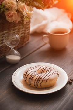 white donut with chocolate on brown table