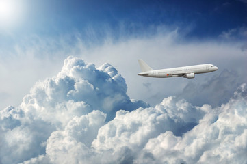 Naklejka na ściany i meble Plane flying through dramatic storm clouds