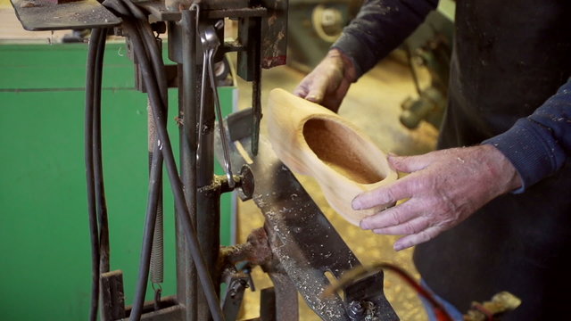 Clog maker drills a hole in the side of clog [Slomo]