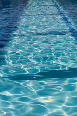 Background of rippled pattern of clean water in a blue swimming pool