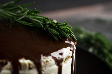 Creamy cake with chocolate glaze on the rustic background
