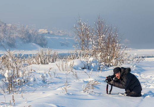 photographer taking photo on the snow