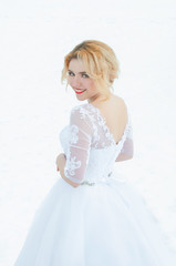 Fototapeta na wymiar Young and beautiful bride in winter