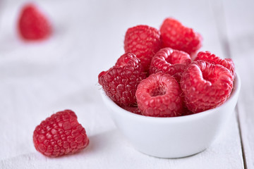 Raspberries on white table