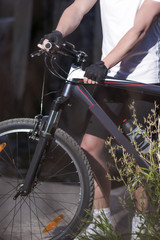 Sport Concept. Closeup of Hands of Male Caucasian MTB Cyclist Outdoors