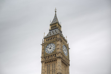 Fototapeta na wymiar detailed close-up of Elizabeth Tower (Big Ben Clocktower) in front of gray cloudy sky, London, United Kingdom, Europe