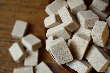 A bowl full of brown sugar cubes