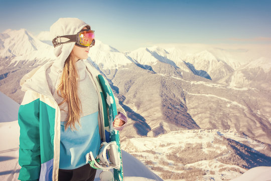 Snowboard. Sport woman in snowy mountains