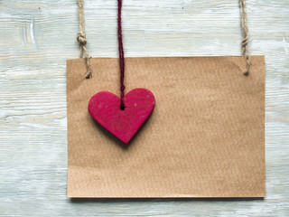 Valentine heart and sign paper on wooden vintage background