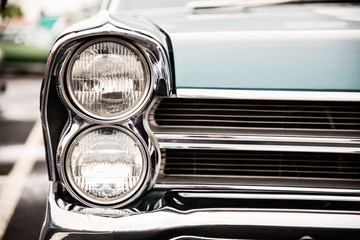 Photograph of a classic vehicle with close-up on headlights.