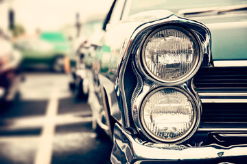 Photograph of a classic vehicle with close-up on headlights.