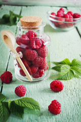 ripe raspberries in a glass jar