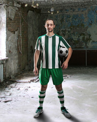 Obraz premium Football-player in a dirty room