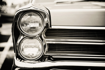 Photograph of a classic vehicle with close-up on headlights.