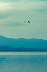 Silhouette paraglider on sunset