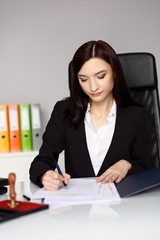 Brunette woman notary public notarizes the contract