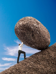 Businessman pushing up boulder © Roman Milert