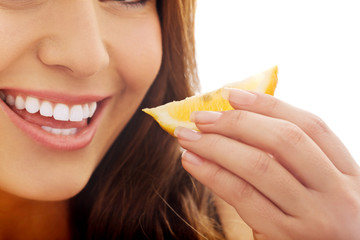 Woman eating lemon.