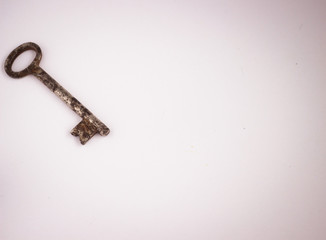 old, rusty key on white background