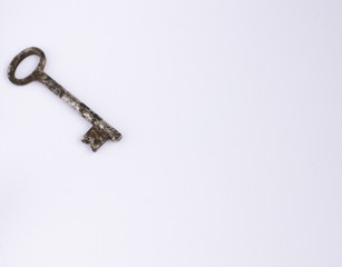 old rusty key on white background