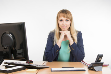 Strict head sitting at a desk