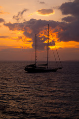 Fototapeta premium Traditional boat at sunset in Santorini island, Greece