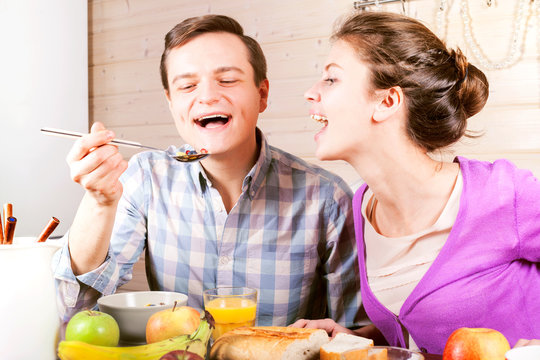 Young Beautiful Couple Having Breakfast At The Table