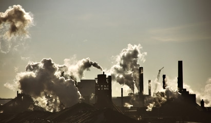 Steel-mill plant scenery line with fuming chimney-stalks in Hamilton Ontario
