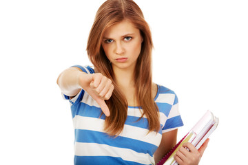 Teenage unhappy woman with thumbs down
