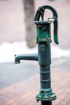 Water hydrand that is green wiht a locked handle