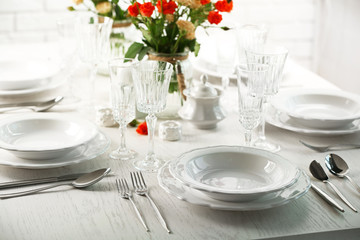 Served table with flowers in restaurant, closeup