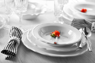 Served table with flowers in restaurant, closeup