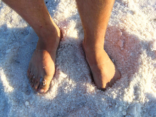 man's legs standing in the healing salt
