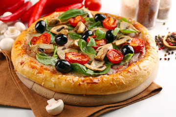 Delicious tasty pizza with vegetables on cutting board