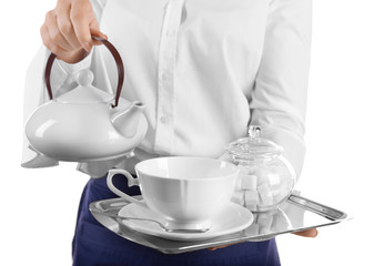 Waiter holding tray with teapot and cup on white background
