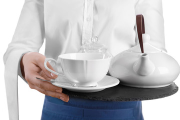 Waiter holding tray with cup and teapot on white background