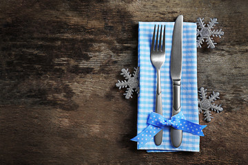 Christmas serving cutlery with napkin on a wooden background