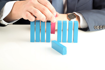 Close-up Of Businessman pushing out  wooden block With Hand At D