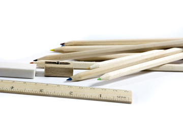 pencil, eraser, sharpener, wood meter on white background