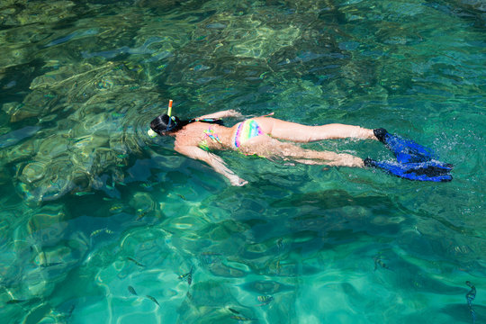 Woman swims among a mask and snorkel, Thailand