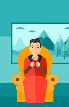 Man sitting in chair with cup of tea.