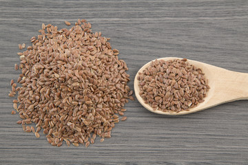 Flax seeds close up on a wooden spoon on a table. horizontal