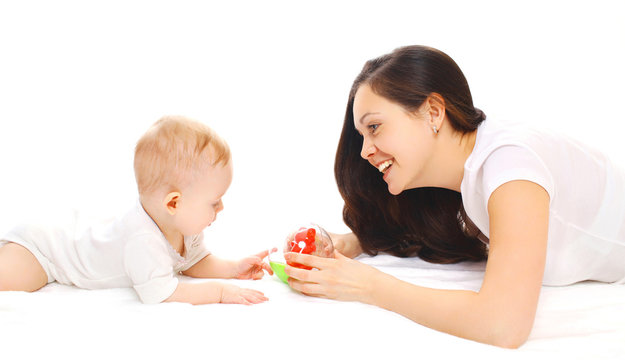 Happy smiling mother and baby playing in toys over white backgro