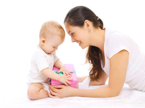 Happy smiling mother and baby with gift box on a white backgroun