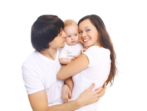 Happy young family, mother and father kissing baby on a white ba